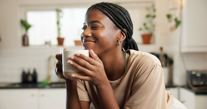 Coffee, happy and black woman in home on morning on weekend for relax, calm or peace in kitchen. Smile, cappuccino and African female person drinking warm beverage, latte or tea in apartment.