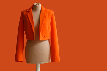 Mannequin for tailor with jacket on orange background