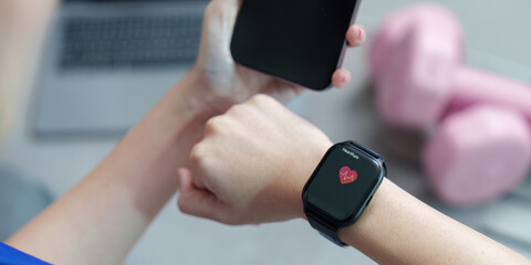 Health Monitoring: Woman Using Smartwatch and Phone for Fitness