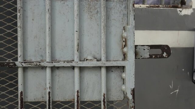 The prison cell door is made of gray iron. 4K Video
