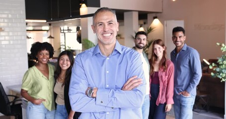 Confident mature business leader posing with his diverse team in the office - Powered by Adobe