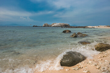 Serene Coastline with Crystal Clear Ocean and Rocky Shore, Sanya, China