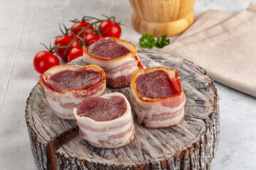 Raw pork tenferloin with bacon