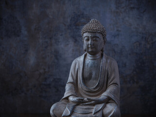 Meditating Buddha Statue on dark background. Soft focus. Close up. Copy space	