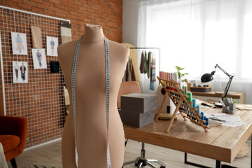 Tailor's mannequin with measuring tape in atelier