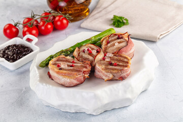 Tasty grilled pork medallion with bacon