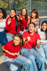 Group of women friends cheering for favorite sports team