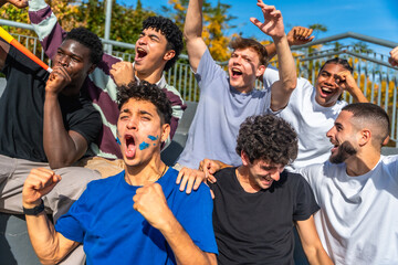 Diverse young men cheering for sports team
