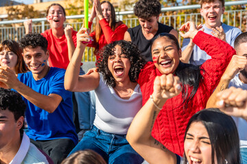 Excited young people cheering at sporting event