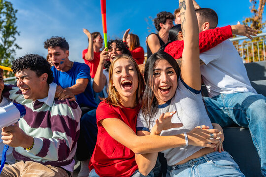 Young friends cheering and celebrating at stadium event