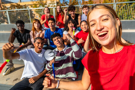Happy young team supporters making selfie at stadium