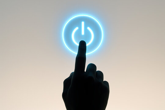 Hand pressing glowing power button