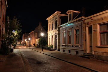 Nighttime Charm of Mainstreet: A Serene Stroll Through Illuminated Buildings and Old Homes