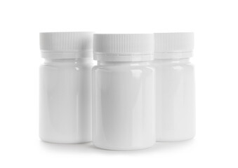 Blank plastic vitamin bottles on white background
