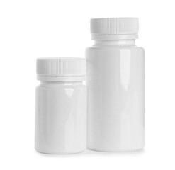 Blank plastic vitamin bottles on white background