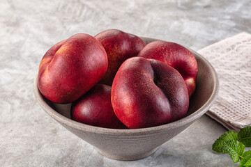 Ripe sweet juicy flat nectarines heap