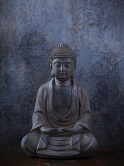 Meditating Buddha Statue on dark background. Soft focus. Close up. Copy space	