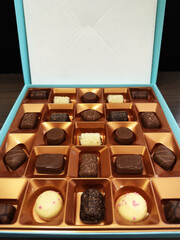 Closeup of a newly opened box of milk and dark chocolates.