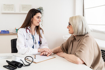 Doctor providing emotional support to a patient during a consultation in a medical office