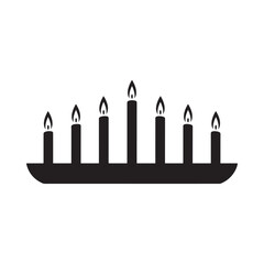 Silhouette of a candelabra with seven lit candles on a white background