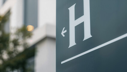 Hotel sign with an arrow pointing left, close-up shot