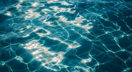 Sunlight reflecting on the surface of clear blue water