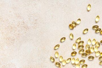 Vitamin E capsules on light background