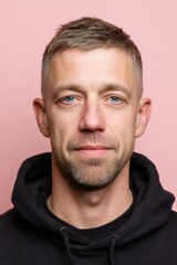 Obraz premium Professional passport ID portrait of a Caucasian German male against a pink backdrop