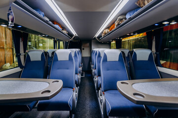 contemporary bus interior, interior of peaceful modern bus with illuminated windows and orderly