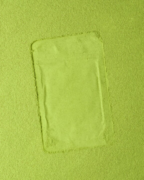 Minimalist matcha powder background with clean pouch imprint offers versatile space for text, branding, or packaging design mockup.