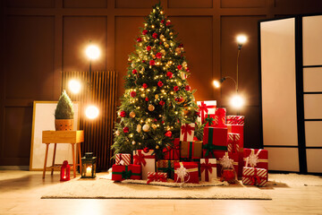 Decorated Christmas tree with many gifts and glowing lamps in living room at night