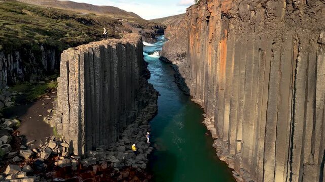 Experience the stunning landscape of Studlagil Canyon, featuring unique basalt columns and crystal-clear water.