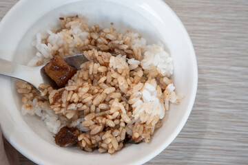 Braised pork belly meat over cooked rice.