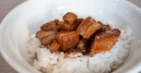 Braised pork belly meat over cooked rice.