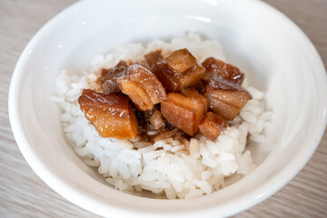 Braised pork belly meat over cooked rice.