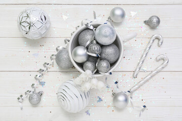 Silver Christmas decor on white wooden background