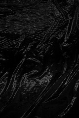 A black, wrinkled textured background