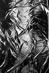 Transparent plastic wrap on a black background