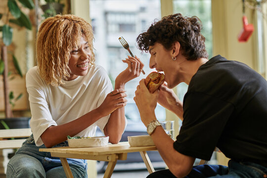 Stylish couple enjoying a cozy meal together in a vibrant cafe setting