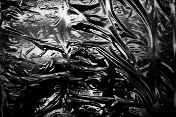 Transparent plastic wrap on a black background