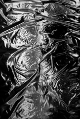 Transparent plastic wrap on a black background