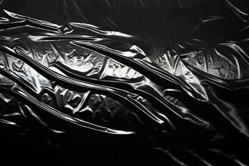 Transparent plastic wrap on a black background