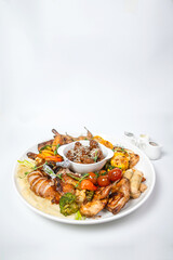 Complete chicken meat set platter with wings, thighs, corn and dipping sauces on white