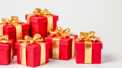 Fototapeta premium Red gift boxes with golden ribbons arranged neatly for a special celebration during the festive season in a cozy indoor setting