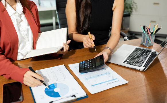 Business team doing paperwork, sitting at cafe on conference. Focused business team learning financial graphs, working on corporate project at briefing meeting.