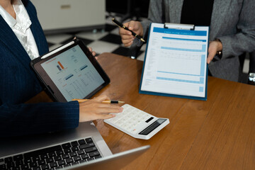 Business team doing paperwork, sitting at cafe on conference. Focused business team learning financial graphs, working on corporate project at briefing meeting.