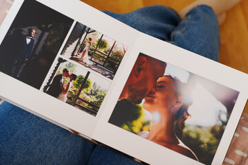 Female hands flipping through a photo book with wedding photos