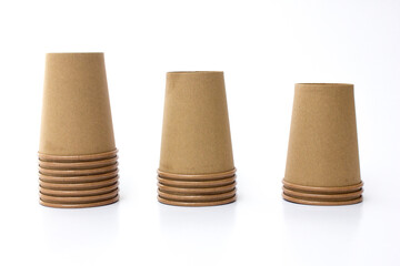 Several stacks of brown paper coffee cups isolated on white background. These cups are eco- friendly, suitable for coffee businesses in cafes.