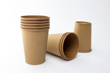 Several stacks of brown paper coffee cups isolated on white background. These cups are eco- friendly, suitable for coffee businesses in cafes.