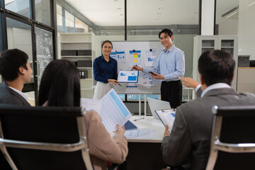 Business, technology and office concept, businessman with laptop, tablet pc computer and papers having discussion in modern office.